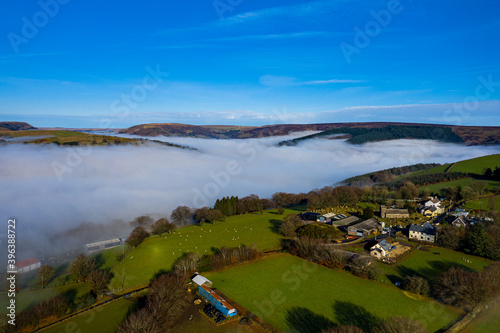 Beautiful morning of drone footage overlooking welsh sceneray with fog sheet covering the lower valleys in south wales uk. photo