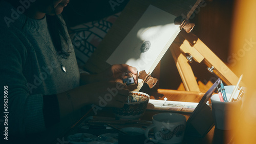 close up of woman sharpening pencil in the sun
