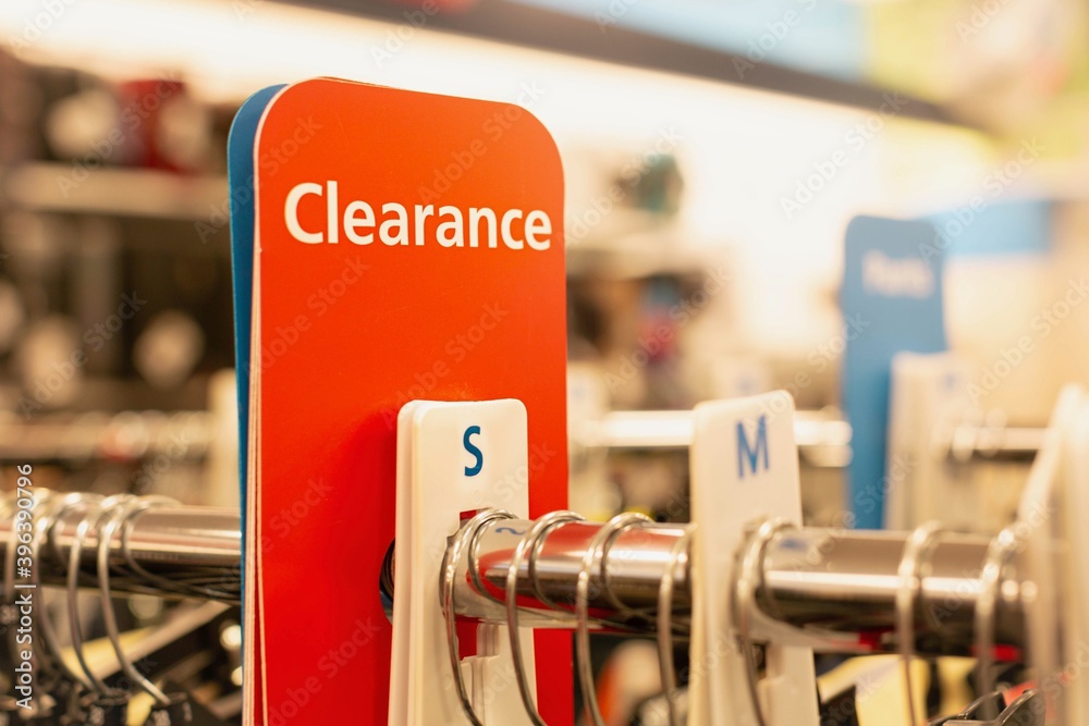 Clearance sign in a clothes department store. On sale section.