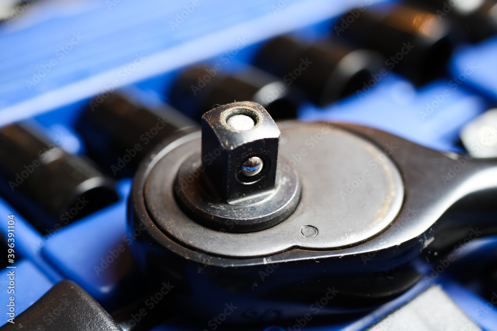 Macro close up of reversibel ratchet wrench head on socket set box