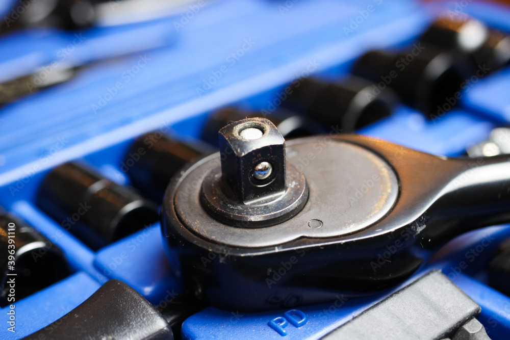 Macro close up of reversibel ratchet wrench head on socket set box Macro close up of reversibel ratchet wrench head on socket set box