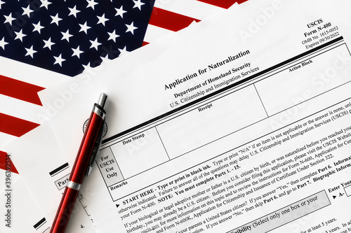 close-up of n-400 form. application for naturalization topview, on a background of United States flag.