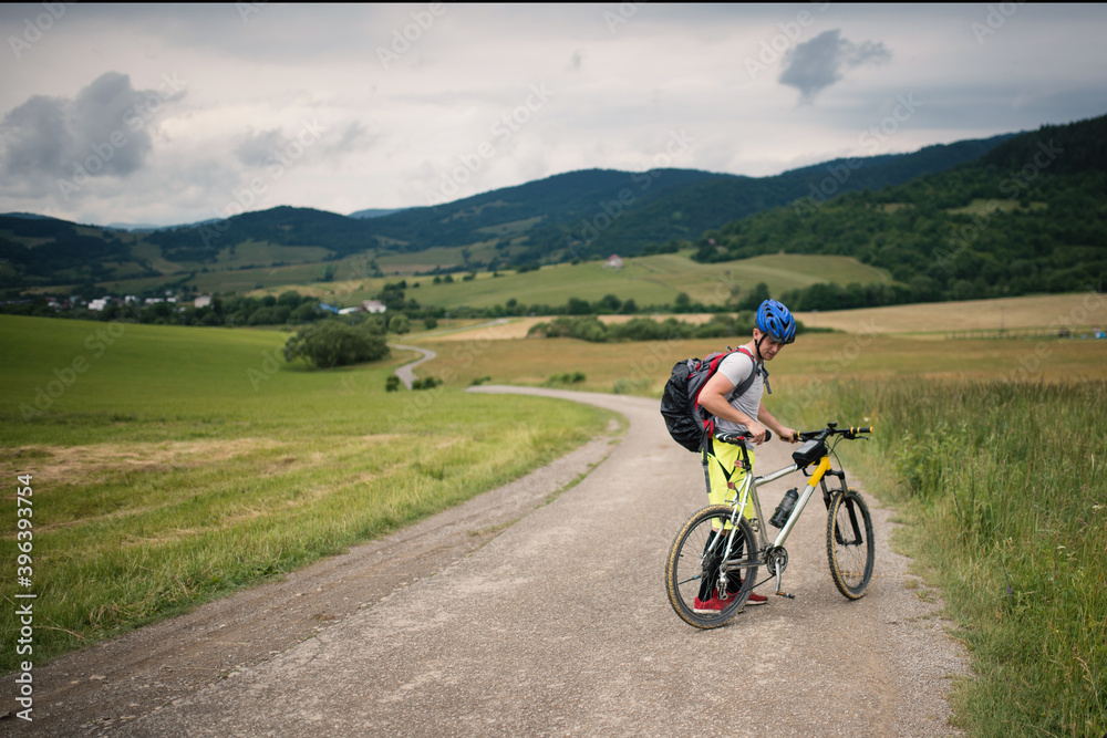 Young athlete man with bicycle in the nature.