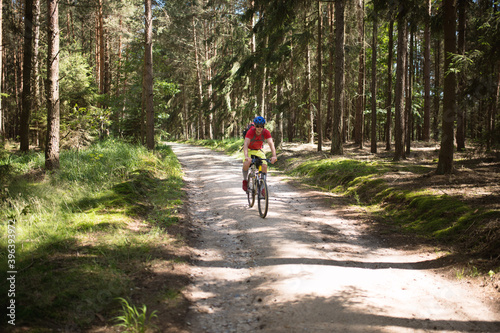 Young athlete man with bicycle in the nature.