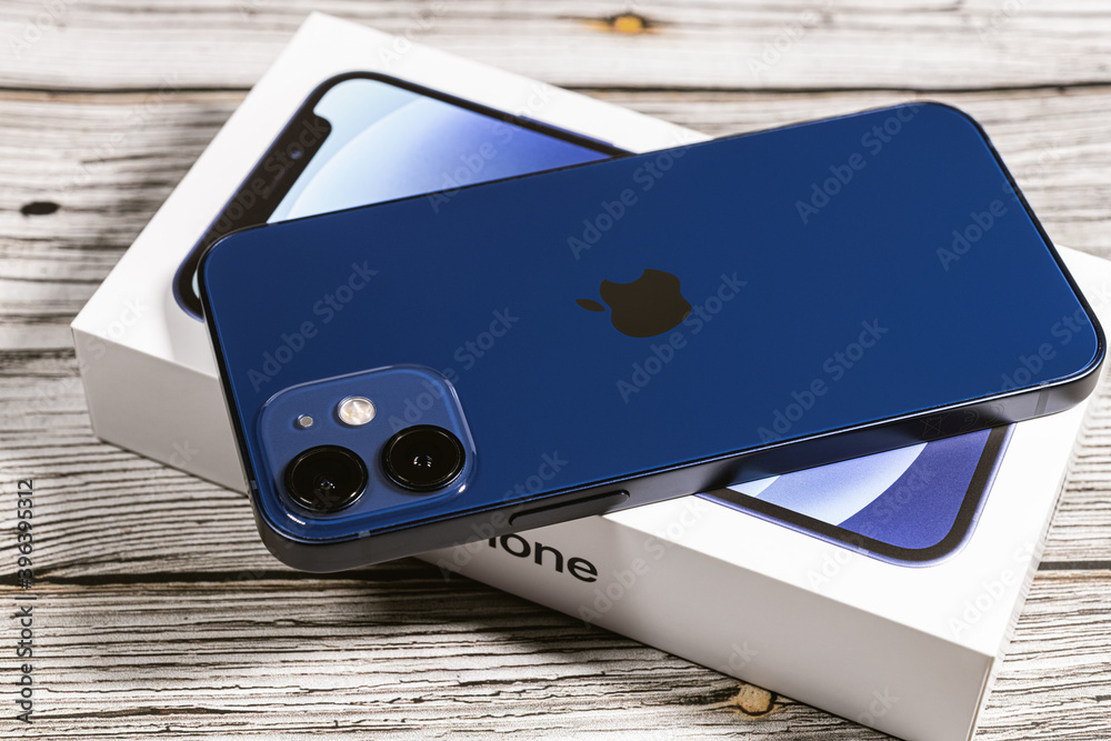 Saint Petersburg, Russia - November 28, 2020: Studio shot of brand new  Apple iPhone 12 mini blue rear view on the box on wooden background.  Unpacking purchase concept. Photos | Adobe Stock