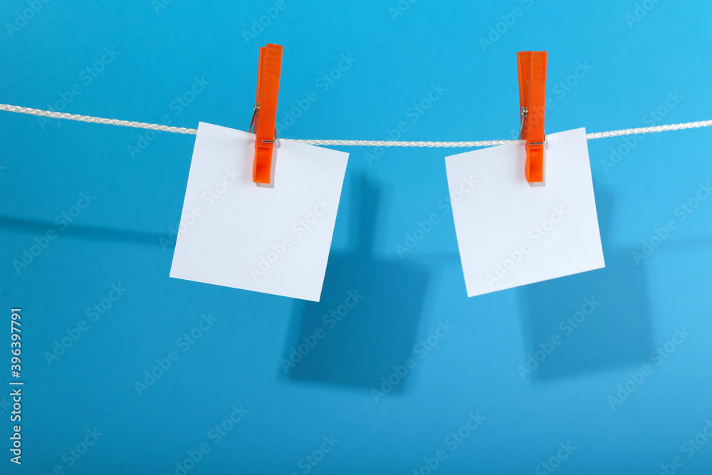 sheets of paper are hung with a clothespin on a rope sheets of paper are hung with a clothespin on a rope