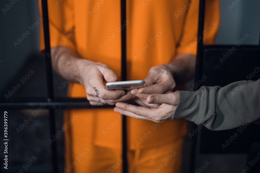 The criminal in the prison cell received a smartphone to communicate with relatives The criminal in the prison cell received a smartphone to communicate with relatives