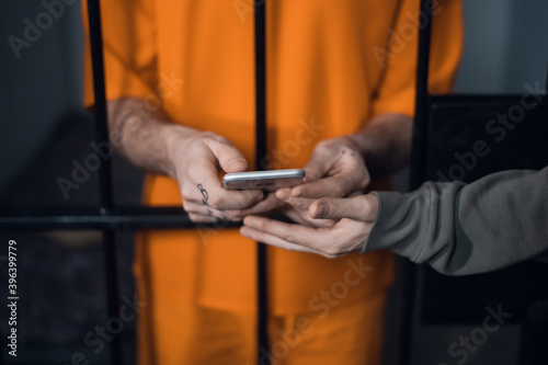 Canvastavla The criminal in the prison cell received a smartphone to communicate with relati