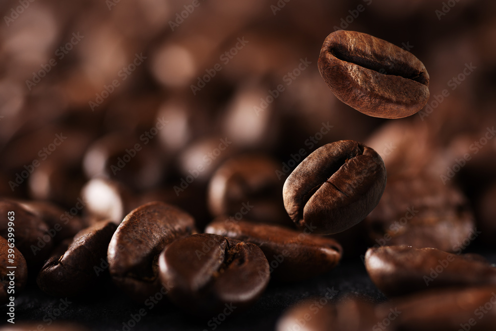 Falling roasted coffee beans background with copy space. Coffee beans in the factory. Coffee beans fall onto the table. - obrazy, fototapety, plakaty 