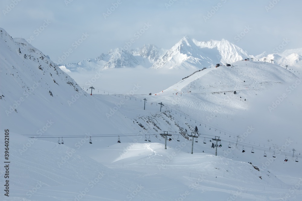 Skiing slopes in the French Alpes above the clouds, winter ski resort