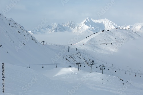 Skiing slopes in the French Alpes above the clouds, winter ski resort © Gudellaphoto