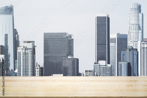 Empty table top made of wooden dies with Los Angeles city view at daytime on background  template