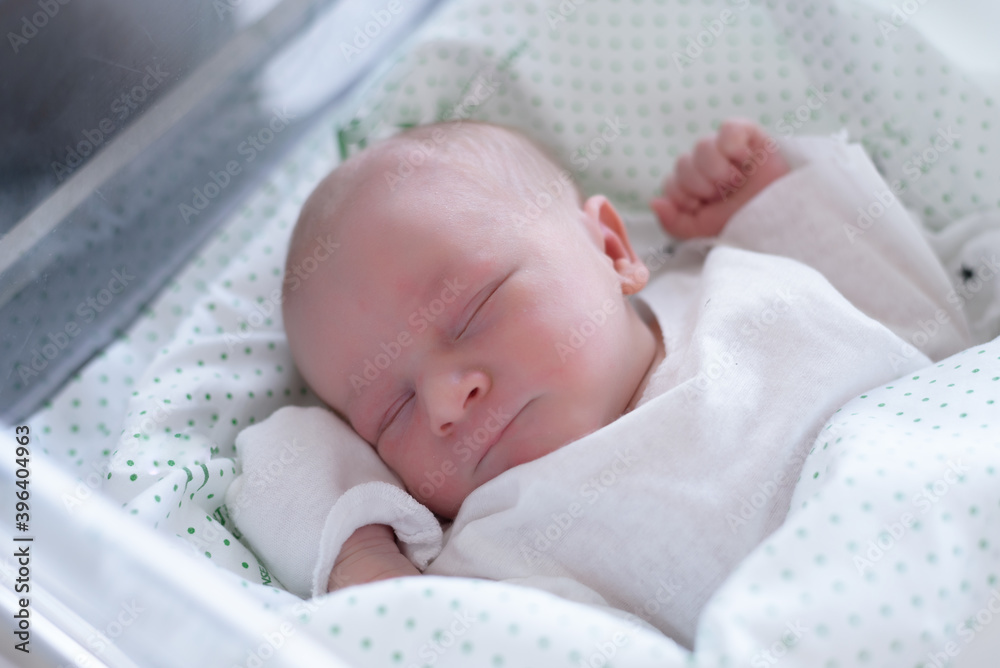 new born infant asleep in the blanket in delivery room new born infant asleep in the blanket in delivery room