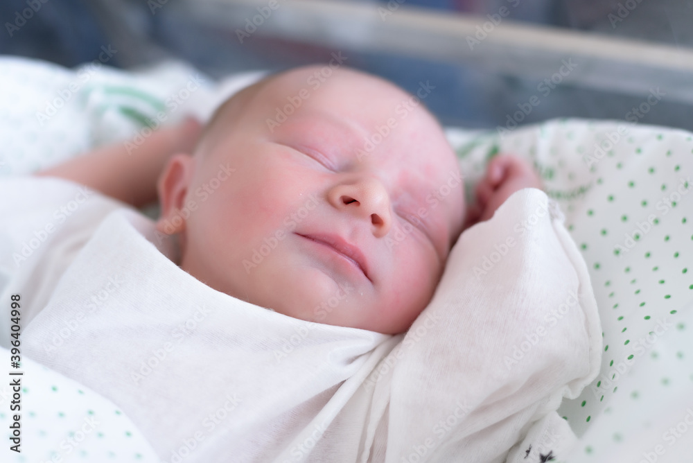 new born infant asleep in the blanket in delivery room new born infant asleep in the blanket in delivery room