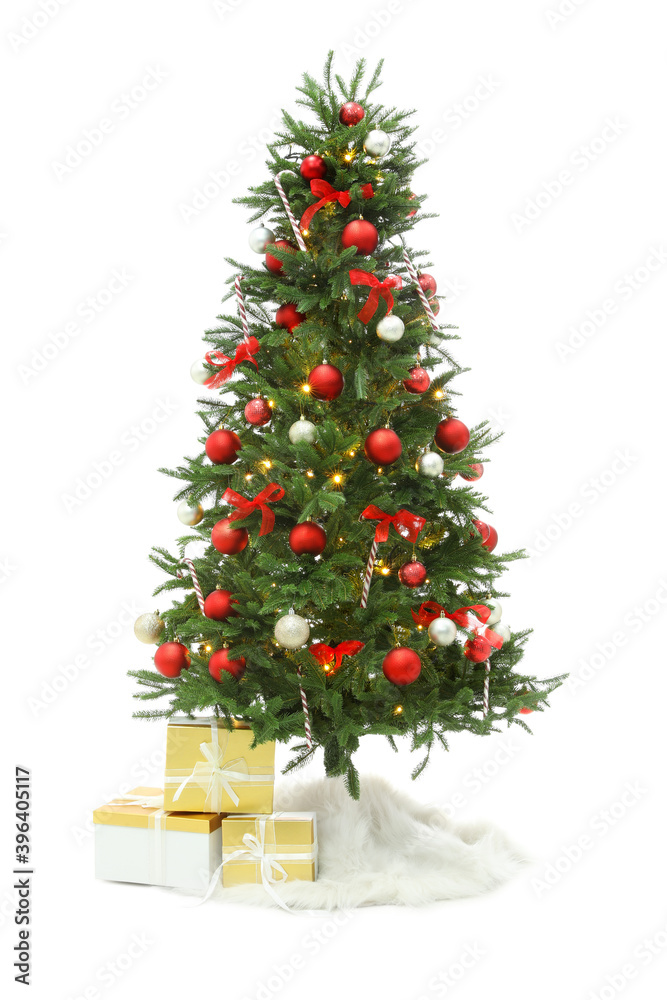 Beautiful decorated Christmas tree with skirt and gift boxes on white background