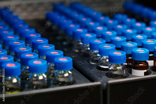 HPLC glass vials in the rack. Research and development of pharmaceuticals and vaccines. High performance liquid chromatography at analytical chemistry laboratory 