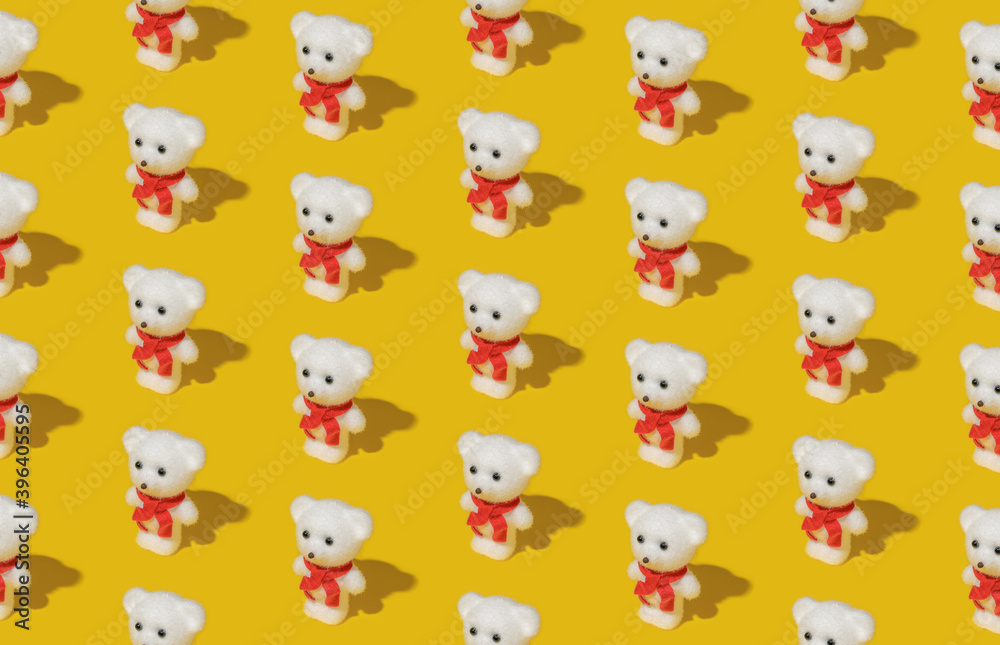Minimal composition pattern background of white teddy bear with red scarf on bright yellow background. Christmas concept. Isometric view