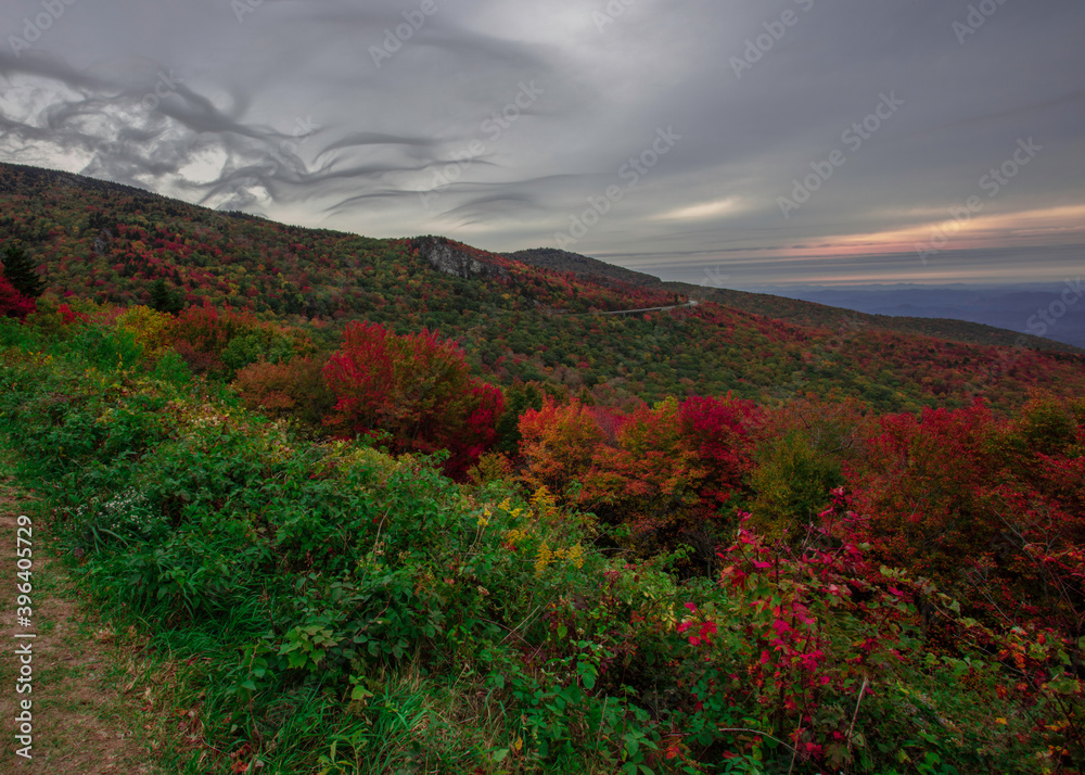 Unusual cloud formations build above the mountaintop of the Blue Ridge Parkway of North Carolina during peak fall colors