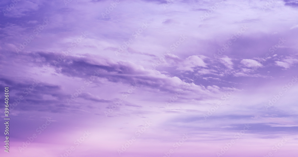 Beautiful purple sky background. Soft white clouds at sunset. Many pink and magenta tones and patterns of clouds