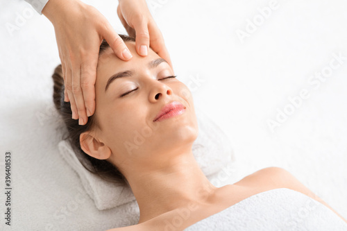 Beautiful caucasian lady enjoying acupressure massage at modern spa