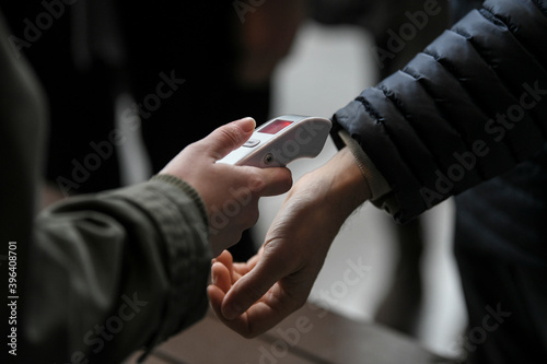 Visitors must go through fever measures using infrared digital thermometer check temperature measurement, fever examination at the building.Measures to prevent people with fever,Corona virus,Covid-19.