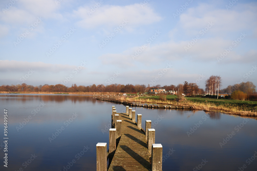 Water with reed strips and wooden piers on the Rottemeren