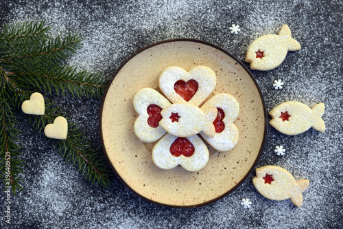 Heart and fish shaped linzer cookies filled with strawberry jam, with romantic festive Christmas decoration