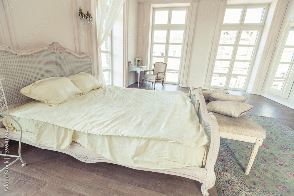 beautiful white bright clean interior bedroom in luxurious baroque style.