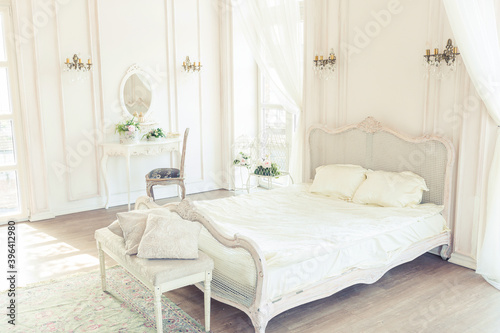 beautiful white bright clean interior bedroom in luxurious baroque style.