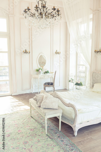 beautiful white bright clean interior bedroom in luxurious baroque style.