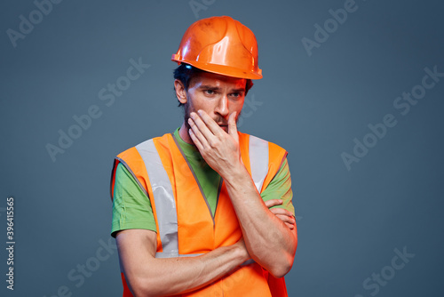 A man in a working uniform a professional construction close-up