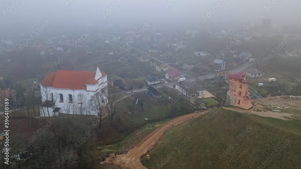 Aerial view of ruins of Tower Shchitovka, Mindovg Castle and Farnese Church of Transfiguration of the Lord in Novogrudok, Belarus. Foggy landscape. Travel in Belarus concept.