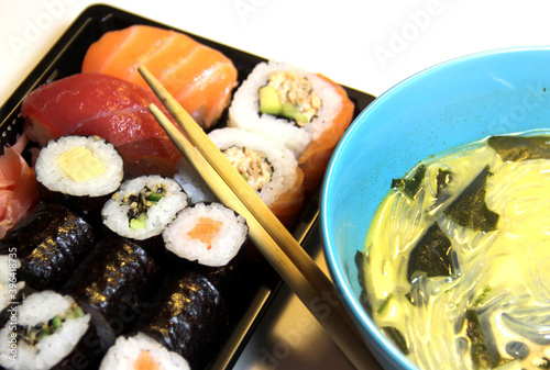 Mix of Sushi, sashimi, maki and thai soup photo