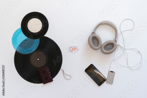 analog versus digital music, headphones and vinyl cassette flat lay photo