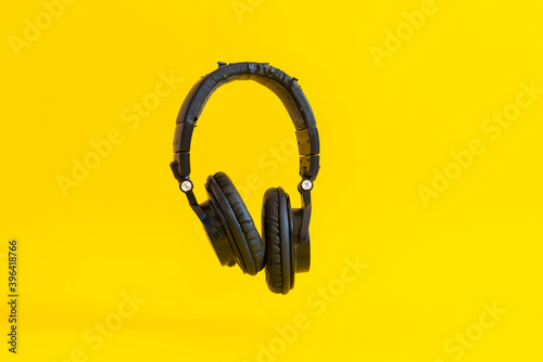 simple wireless headphones isolated floating in the air against the colorful background