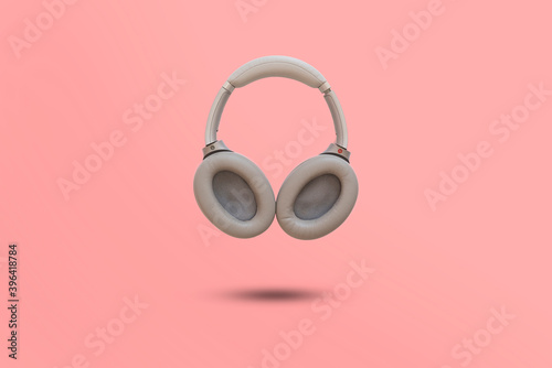 simple wireless headphones isolated floating in the air against the colorful background