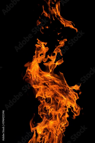 Bright orange red fire flame against black background, abstract texture