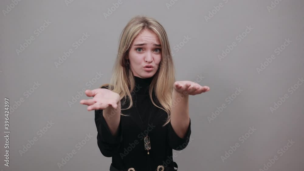 Claw hands, hand gesture and sign, scary desperate, showing claws, nails, making silly face. Young attractive woman, dressed black sweater with green eyes, blonde hair, background Claw hands, hand gesture and sign, scary desperate, showing claws, nails, making silly face. Young attractive woman, dressed black sweater with green eyes, blonde hair, background
