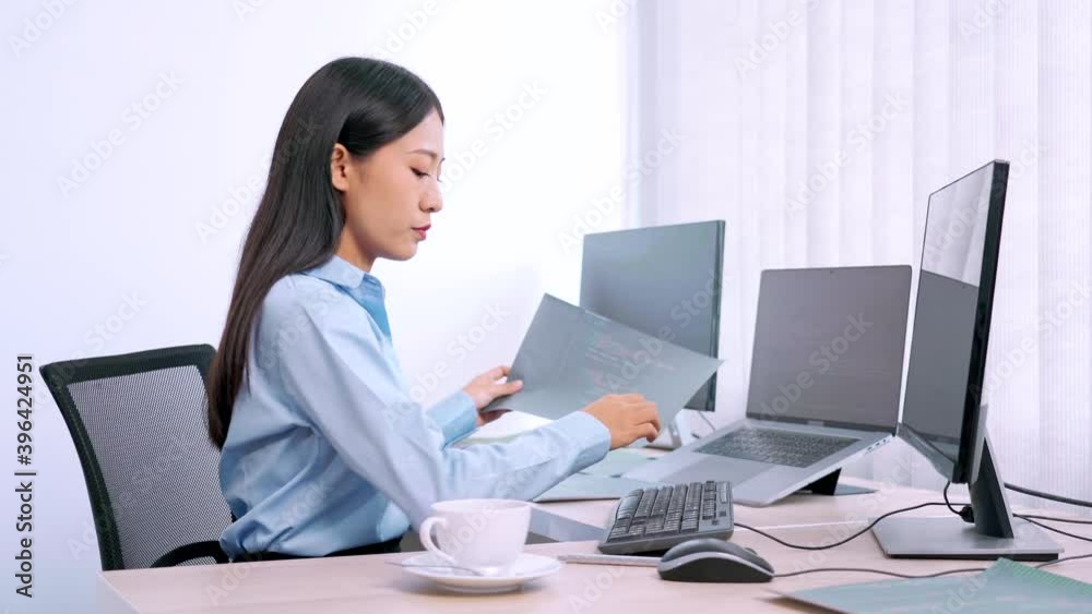 Asian woman programmer typing source code with computer pc for Developing program or application in her office Asian woman programmer typing source code with computer pc for Developing program or application in her office