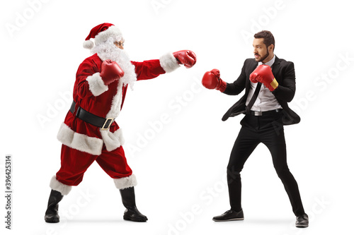 Santa claus boxing with a businessman