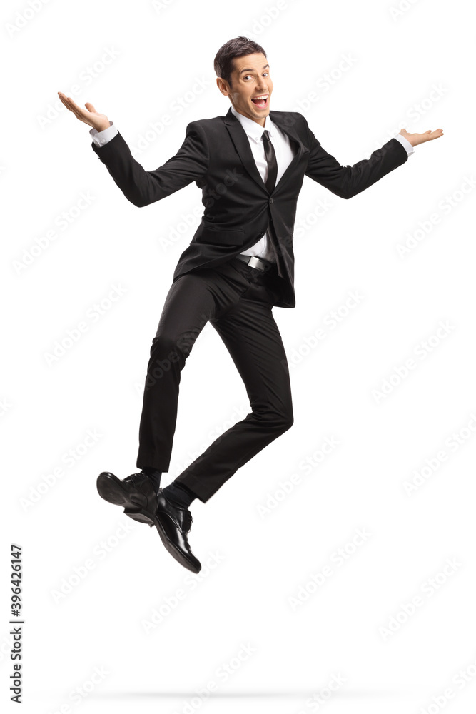 Excited young businessman in suit and tie jumping