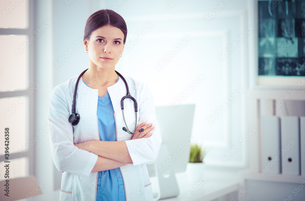 Young smiling female doctor with stethoscope at doctor's office Young smiling female doctor with stethoscope at doctor's office