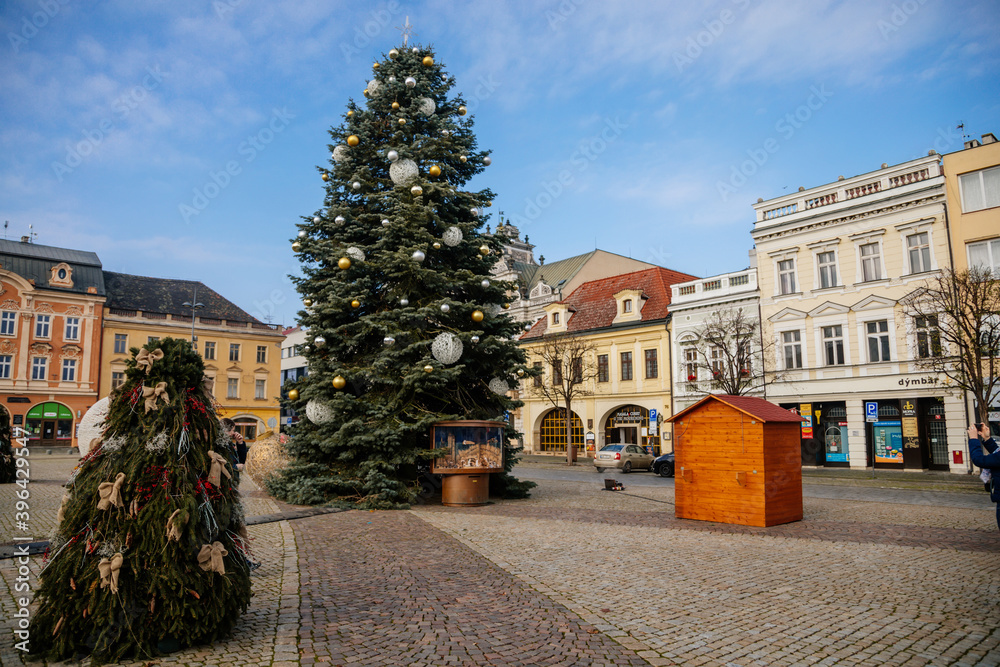 Main town Charles' square with baroque fountain, historic houses with stucco, Christmas tree and Christmas decorations in Kolin, Central Bohemia, Czech Republic