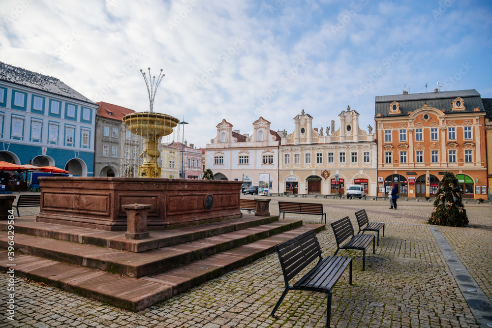 Main town Charles' square with baroque fountain, historic houses with stucco, Christmas decorations in Kolin, Central Bohemia, Czech Republic