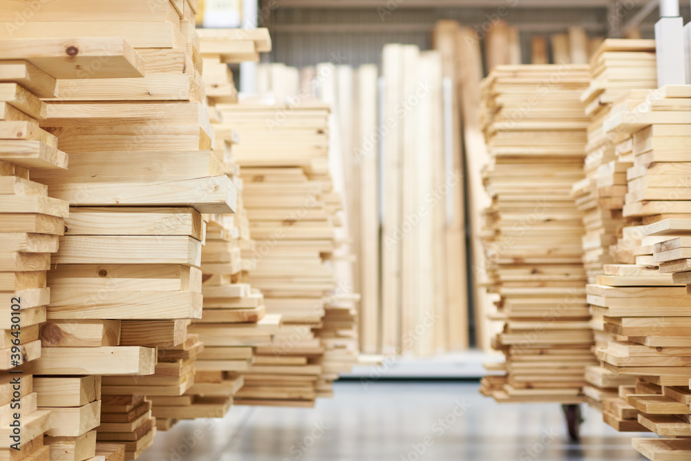 stacked wooden boards in a woodworking industry. stacks with pine lumber. folded edged board. wood harvesting shop. timber for construction stacked wooden boards in a woodworking industry. stacks with pine lumber. folded edged board. wood harvesting shop. timber for construction