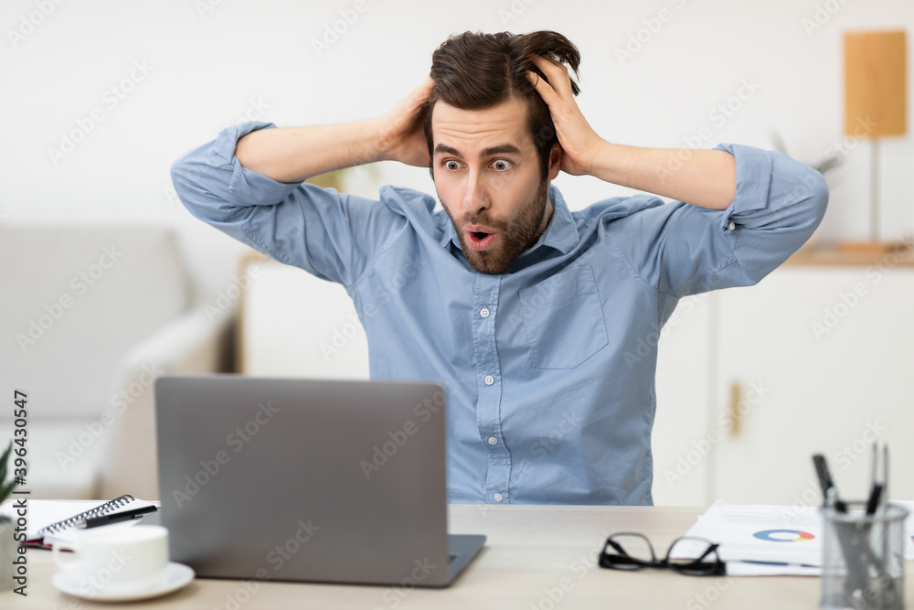 Shocked Frustrated Businessman Looking At Laptop Touching Head At Workplace Shocked Frustrated Businessman Looking At Laptop Touching Head At Workplace