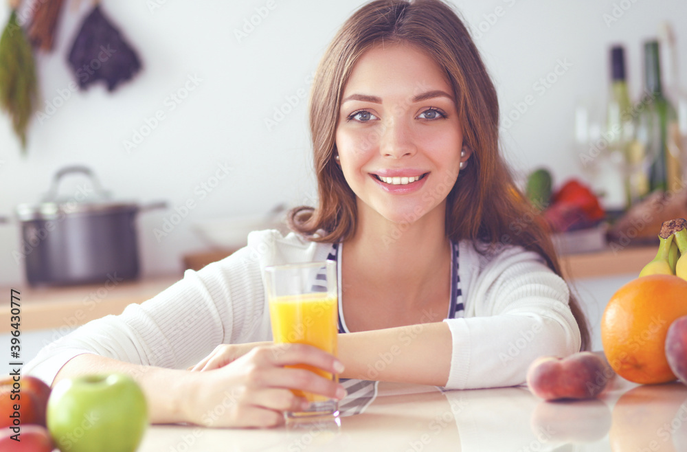 Young woman sitting near desk in the kitchen Young woman sitting near desk in the kitchen