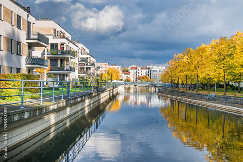 Harbor basin Tegeler Hafen with autumn coloured trees in Berlin, Germany