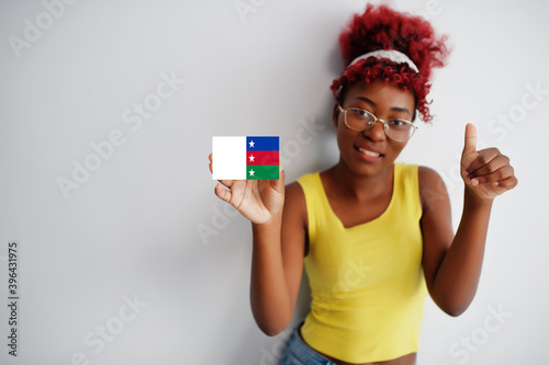 African woman with afro hair hold Bayelsa flag isolated on white background, show thumb up. States of Nigeria concept. photo