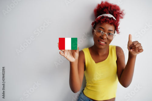 African woman with afro hair hold Nasarawa flag isolated on white background, show thumb up. States of Nigeria concept. photo